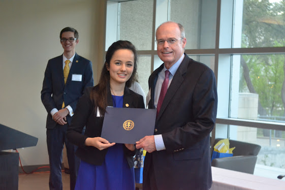 Naomi D’Amato, Professional Development Director, UTD Chapter of Golden Key, presenting certificate of honorary membership. In background is Matt Gillings, President of the UTD chapter