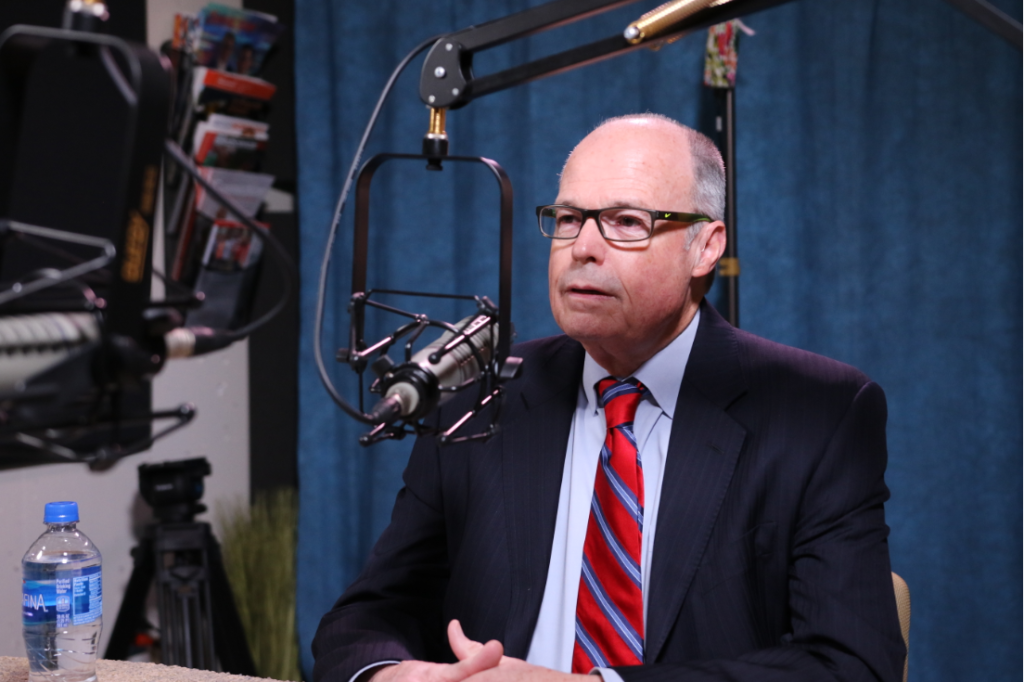 Image: Richard M. Bowen responds into mic in studio.