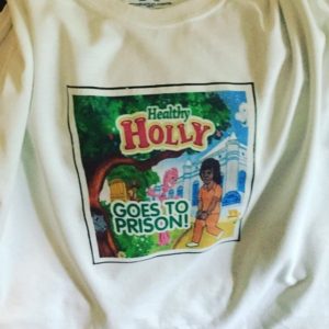 Image: T-shirt with Healthy Holly Goes to Prison book cover