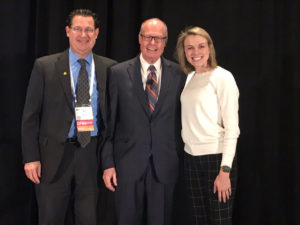 Picture of Moe Allain, Richard M. Bowen and Kristen Newcomer standing before a black background.