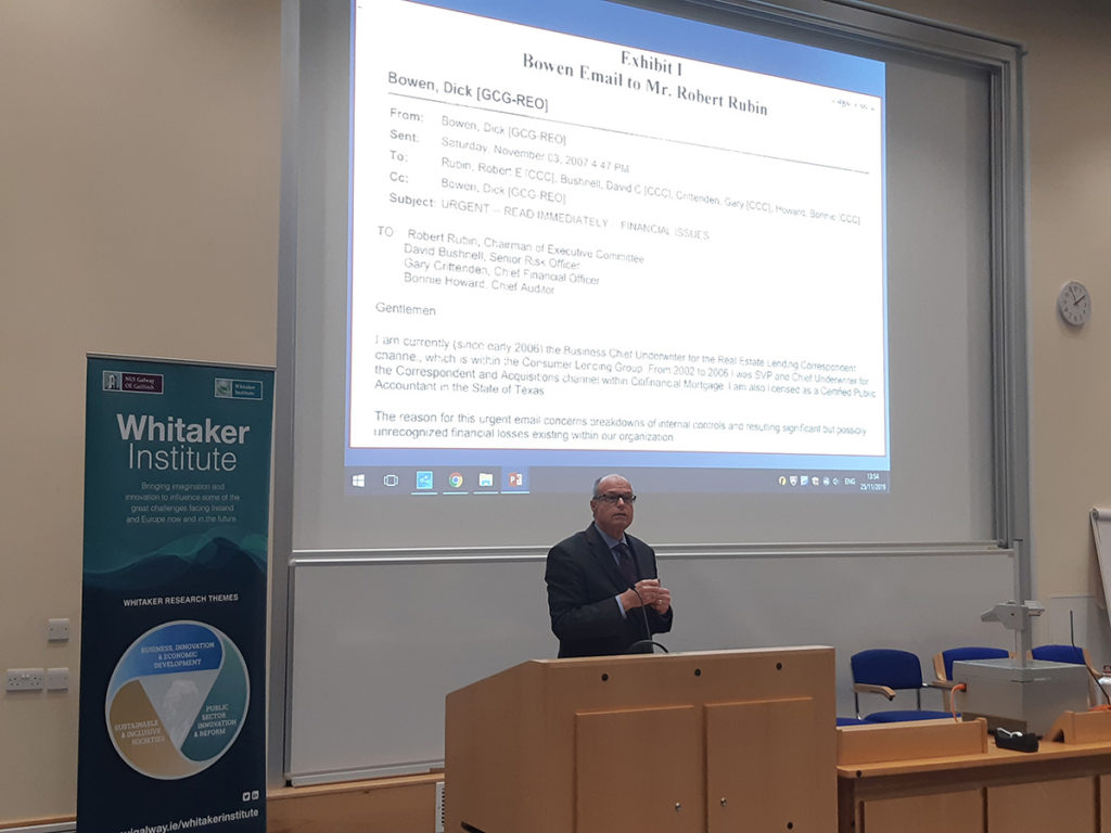 Photo of Richard M Bowen speaking at The Whitaker Institute with a slide of his 2007 email to Rober Rubin.