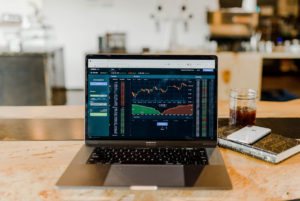 Image of an open laptop with day trading screen.