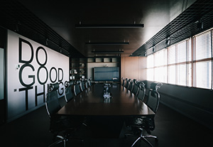 Picture of empty conference room with "Do Good Things" written on the wall.