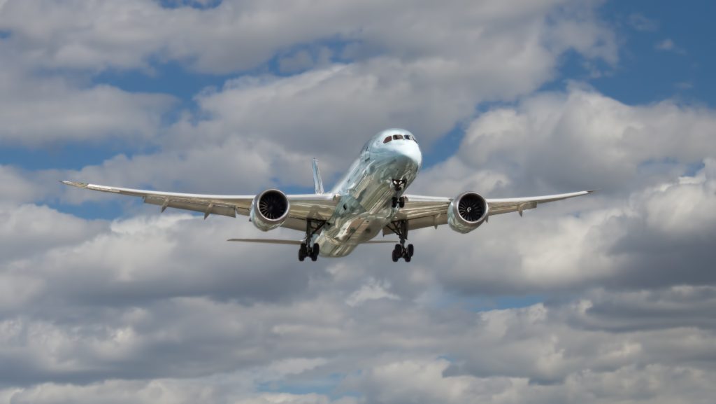 Image: Plane taking off under cumulus clouds