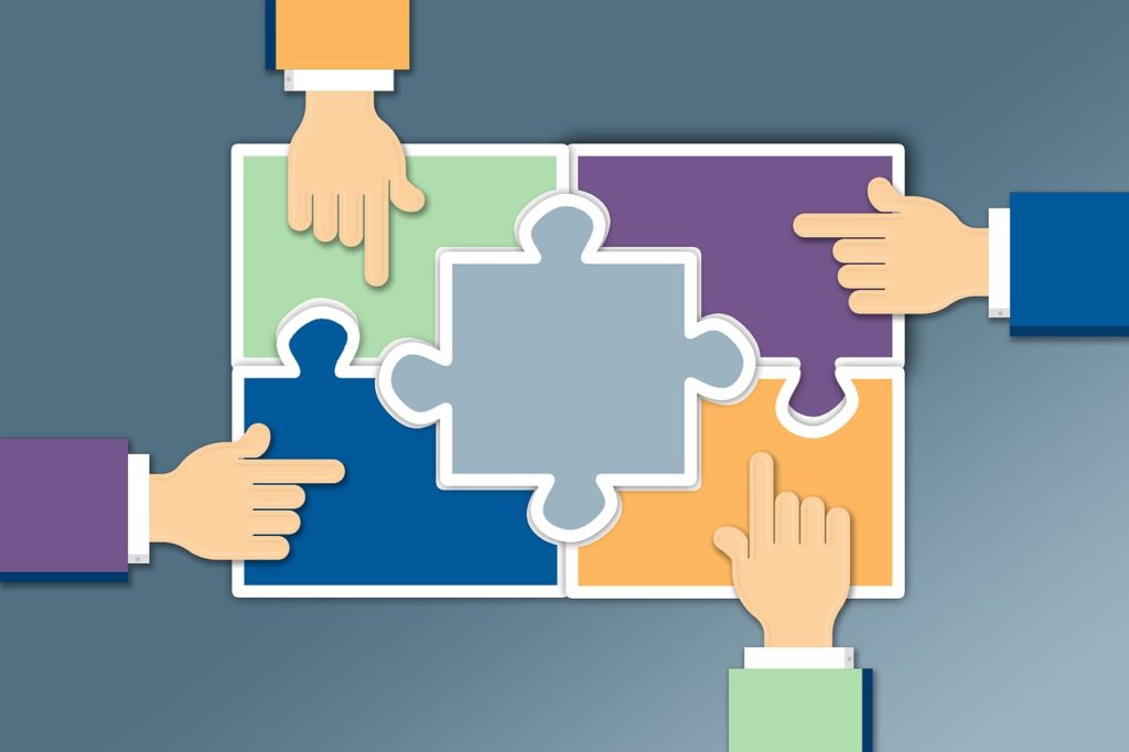 Hands pointing over puzzle pieces