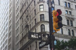 Image: Wall street building behind street light.