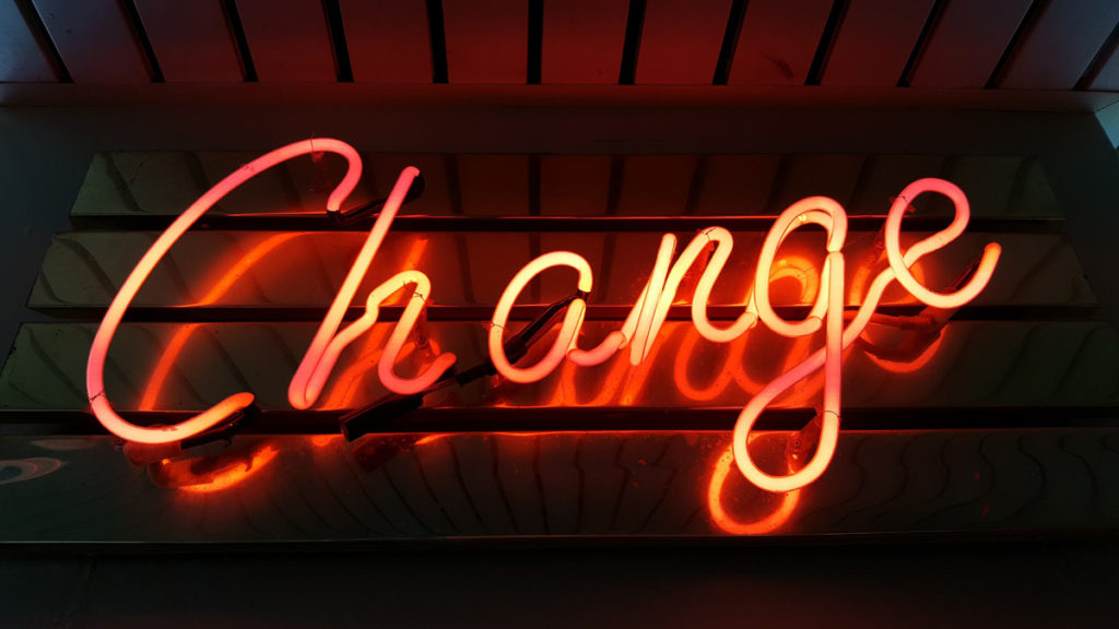 Image of orange neon sign that says "Change"