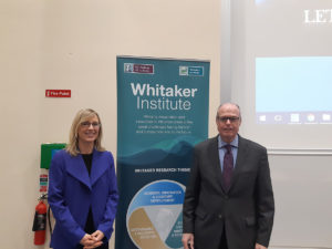 Photo of Kate Kenny and Richard M. Bowen by a sign for the Whitaker Institute.